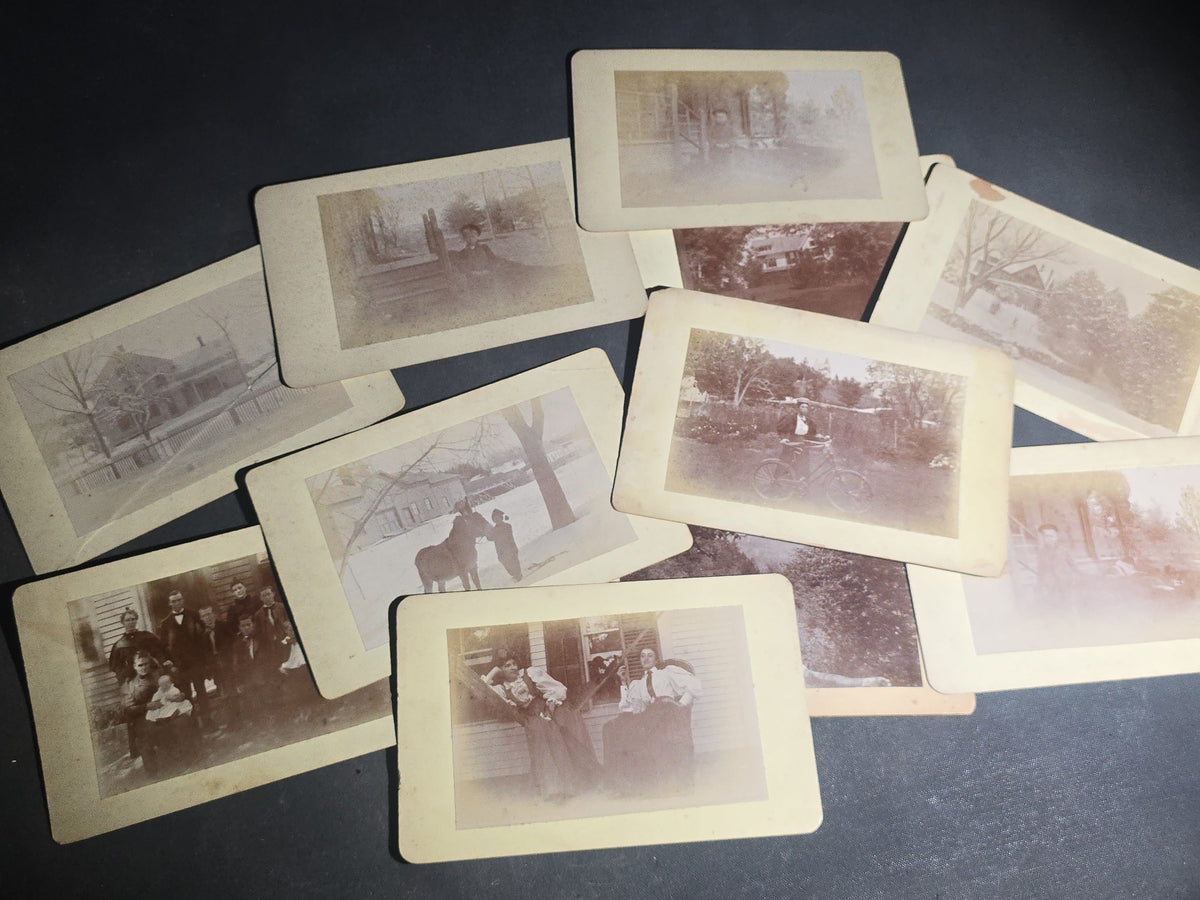Grouping of 11 Antique Board-Mounted Photographs, Circa 1890s, including Woman with Bicycle, Boy with Donkey in Snow, Boy with Dogs, Family Portrait, Women on Porch, and Winter House Scenes