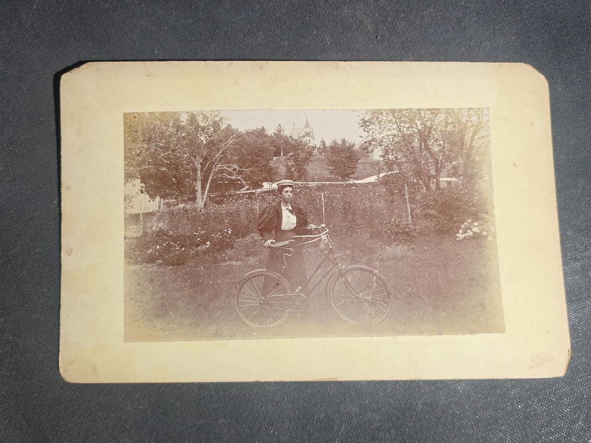Grouping of 11 Antique Board-Mounted Photographs, Circa 1890s, including Woman with Bicycle, Boy with Donkey in Snow, Boy with Dogs, Family Portrait, Women on Porch, and Winter House Scenes