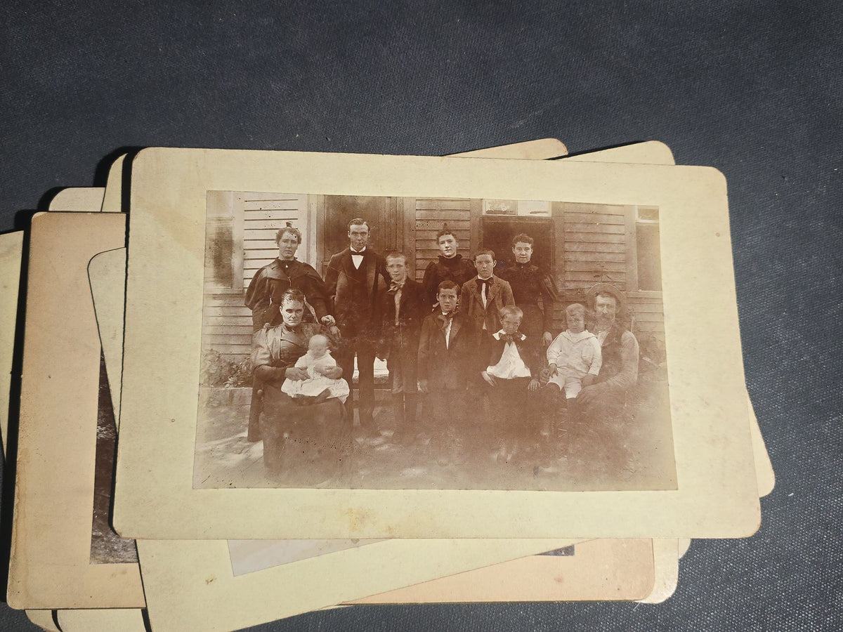 Grouping of 11 Antique Board-Mounted Photographs, Circa 1890s, including Woman with Bicycle, Boy with Donkey in Snow, Boy with Dogs, Family Portrait, Women on Porch, and Winter House Scenes