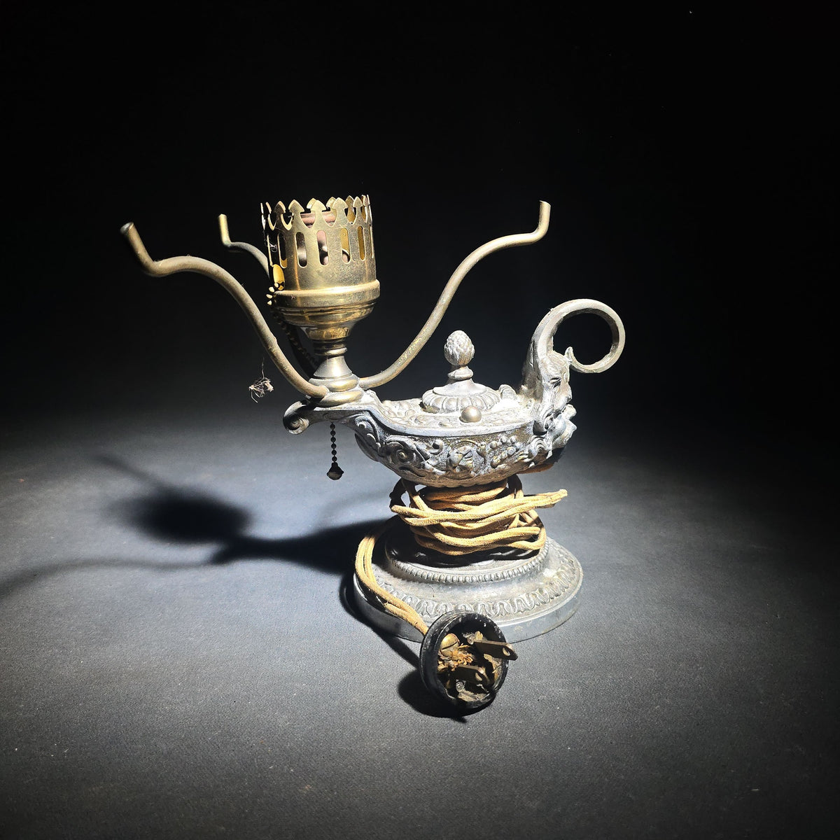 Antique Cast Metal Aladdin Lamp Form Electric Table Lamp with Grotesque Face and Scrollwork on Weighted Base