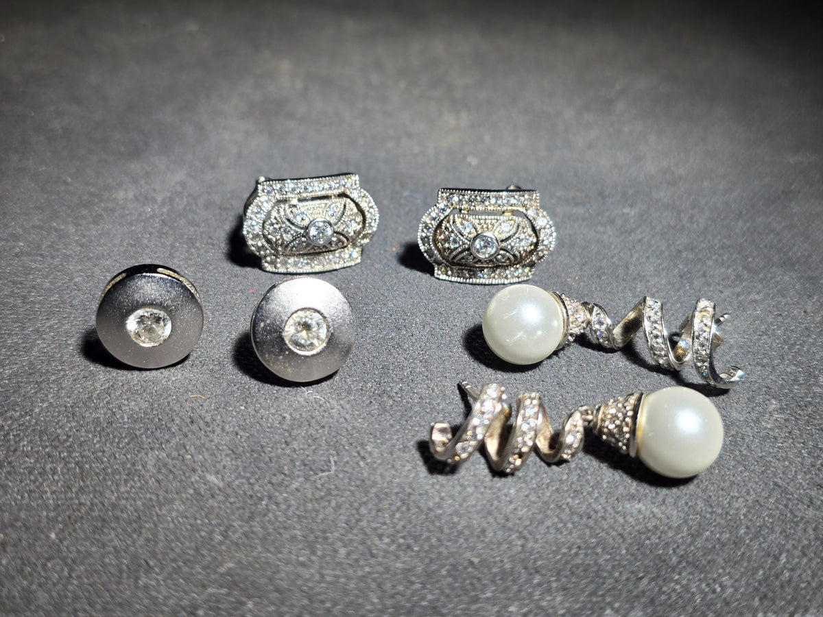 Grouping of Three Pairs of Vintage Sterling Silver Earrings including Filigree Clip-Ons with Clear Stones, Spiral Drop Earrings with Faux Pearls, and Brushed Dome Studs with Center Stones