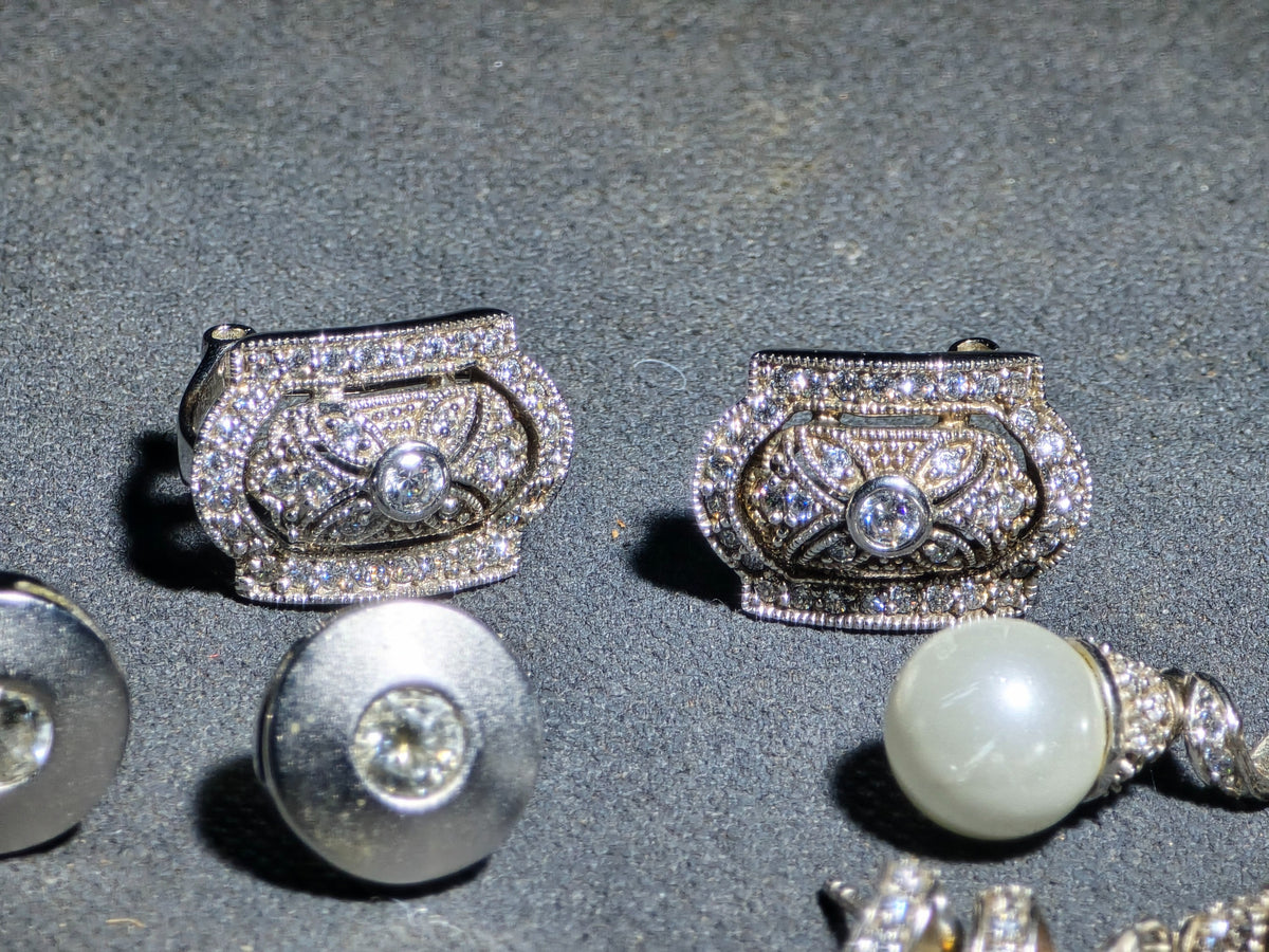 Grouping of Three Pairs of Vintage Sterling Silver Earrings including Filigree Clip-Ons with Clear Stones, Spiral Drop Earrings with Faux Pearls, and Brushed Dome Studs with Center Stones
