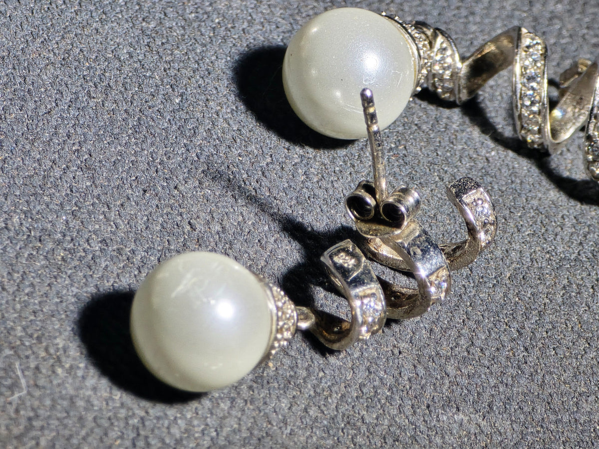 Grouping of Three Pairs of Vintage Sterling Silver Earrings including Filigree Clip-Ons with Clear Stones, Spiral Drop Earrings with Faux Pearls, and Brushed Dome Studs with Center Stones