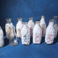 Lot 169 - Grouping of 13 Vintage Printed Glass Dairy Milk Bottles Including Capitol Dairy, Horst Dairy, Aroostook Farms, Sanford Dairy, Rice's, Findeisen's Farms, and Others