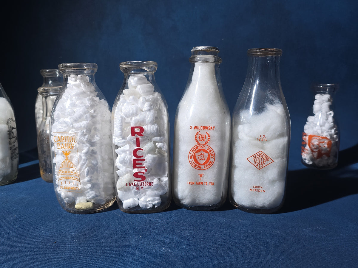 Grouping of 13 Vintage Printed Glass Dairy Milk Bottles including Capitol Dairy, Horst Dairy, Aroostook Farms, Sanford Dairy, Rice's, Findeisen's Farms, and Others