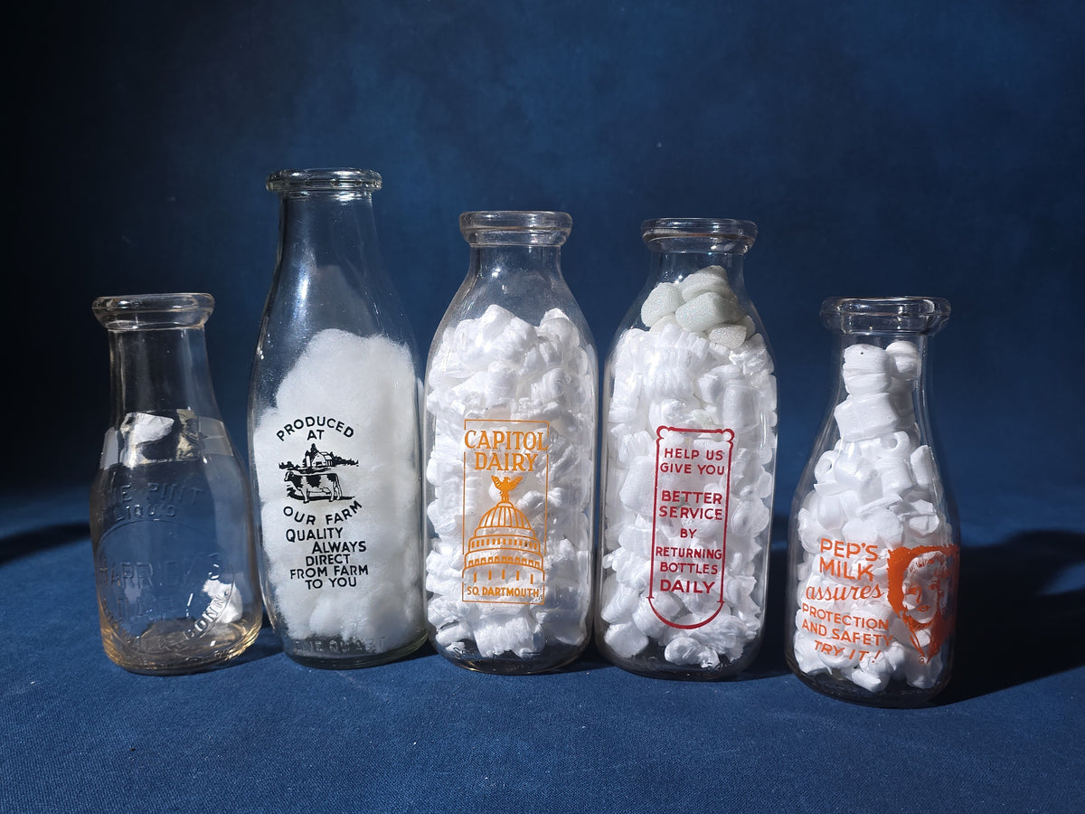 Grouping of 13 Vintage Printed Glass Dairy Milk Bottles including Capitol Dairy, Horst Dairy, Aroostook Farms, Sanford Dairy, Rice's, Findeisen's Farms, and Others