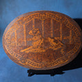 Lot 182 - Antique Flemish Art Co. Pyrography Oval Wood Plaque of a Dog, New York, 22-1/2" W x 16-3/4" H