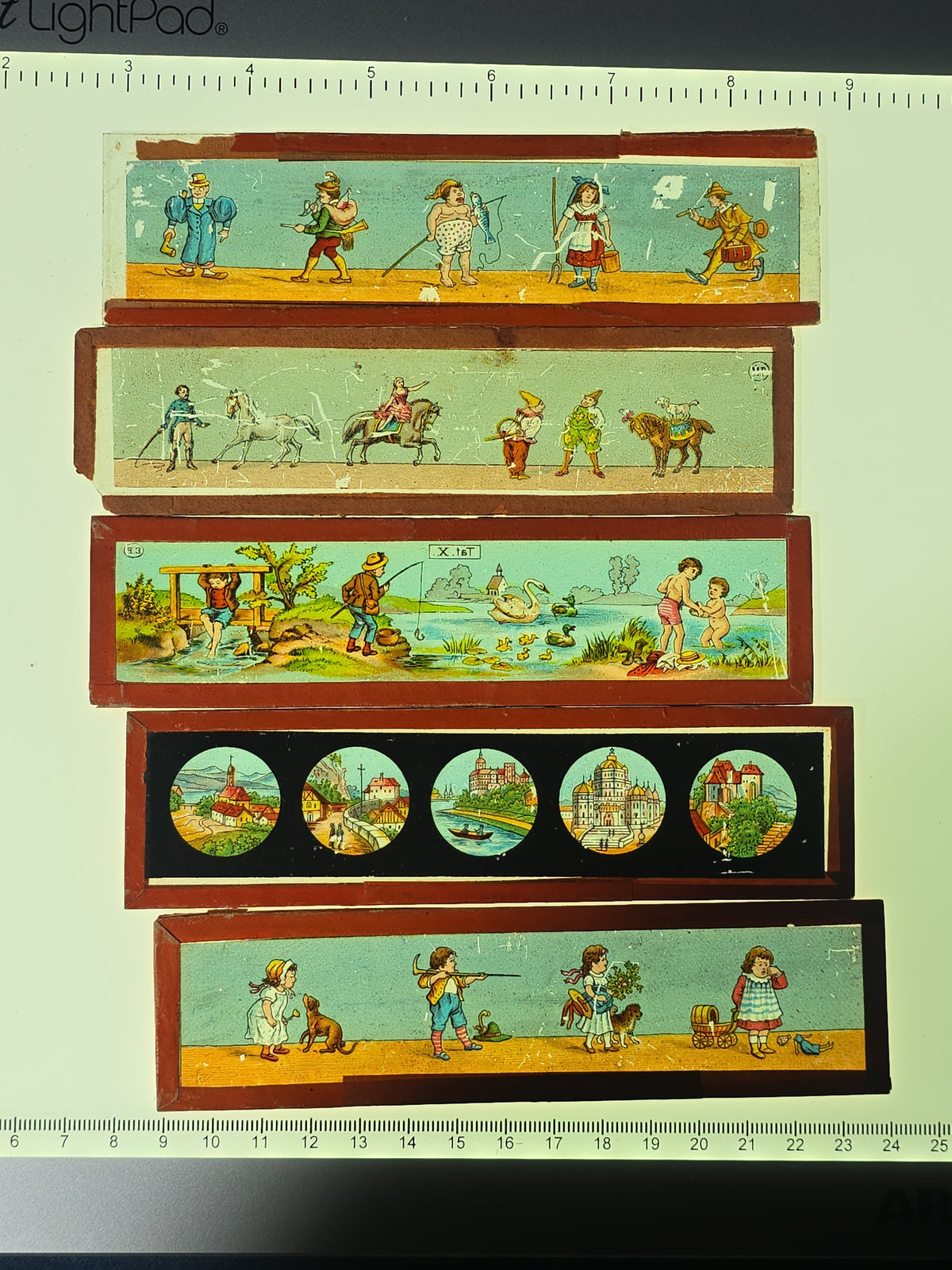 Grouping of 26 Antique Hand-Painted and Chromolithograph Magic Lantern Slides including Rectangular Slides and Round Reel Discs