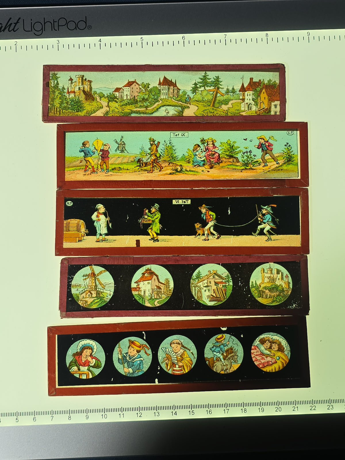 Grouping of 26 Antique Hand-Painted and Chromolithograph Magic Lantern Slides including Rectangular Slides and Round Reel Discs