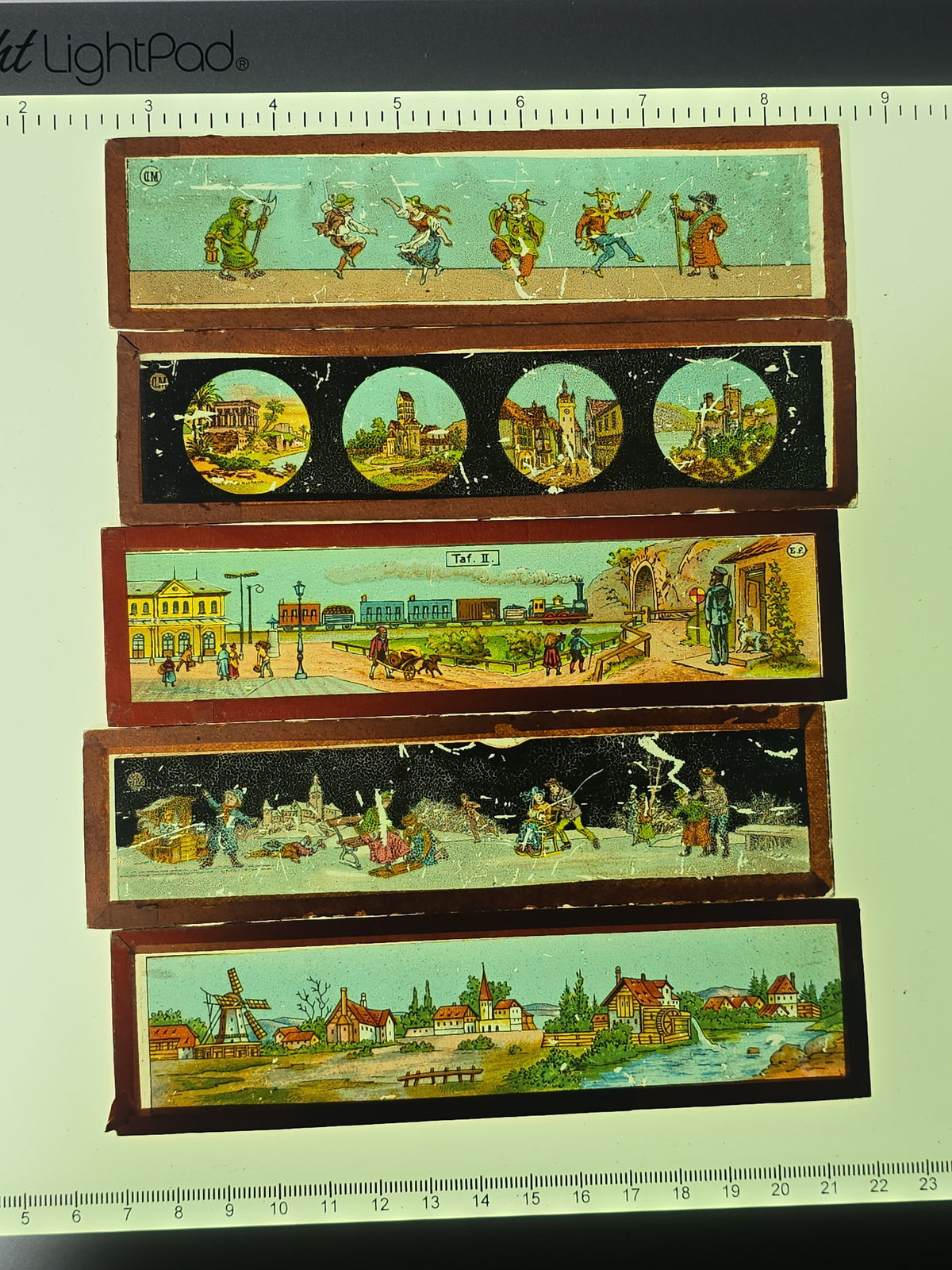 Grouping of 26 Antique Hand-Painted and Chromolithograph Magic Lantern Slides including Rectangular Slides and Round Reel Discs