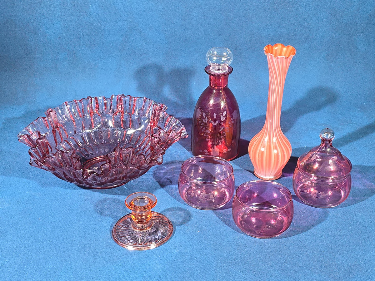 Grouping of Vintage Cranberry and Pink Glass including Ruffled Bowl, Decanter, Striped Bud Vase, Candleholder, and Lidded Jar