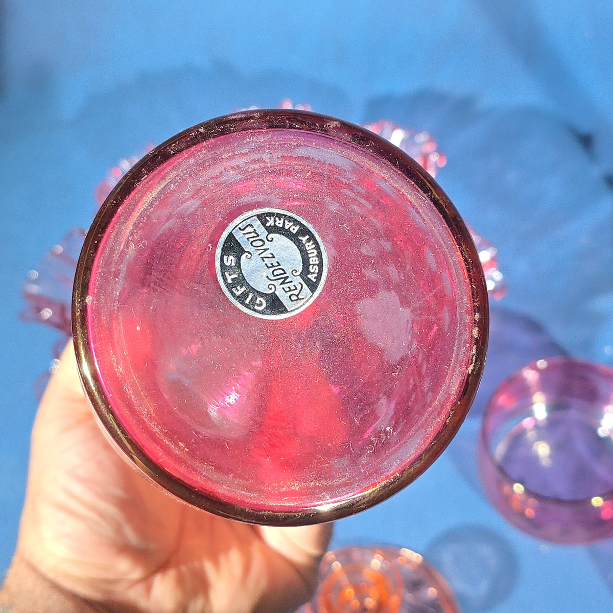 Grouping of Vintage Cranberry and Pink Glass including Ruffled Bowl, Decanter, Striped Bud Vase, Candleholder, and Lidded Jar