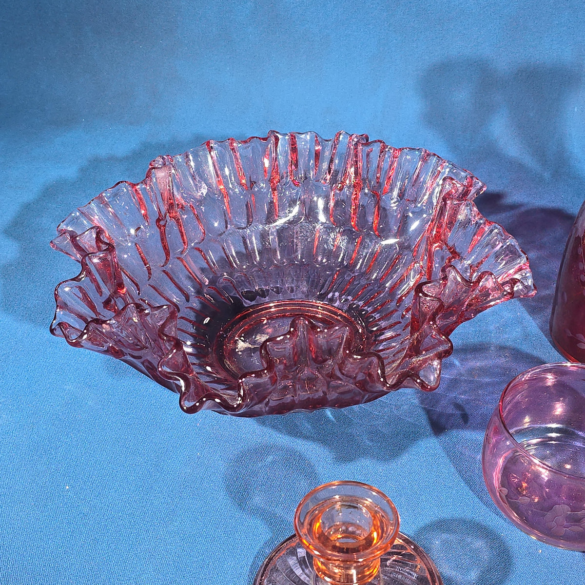 Grouping of Vintage Cranberry and Pink Glass including Ruffled Bowl, Decanter, Striped Bud Vase, Candleholder, and Lidded Jar