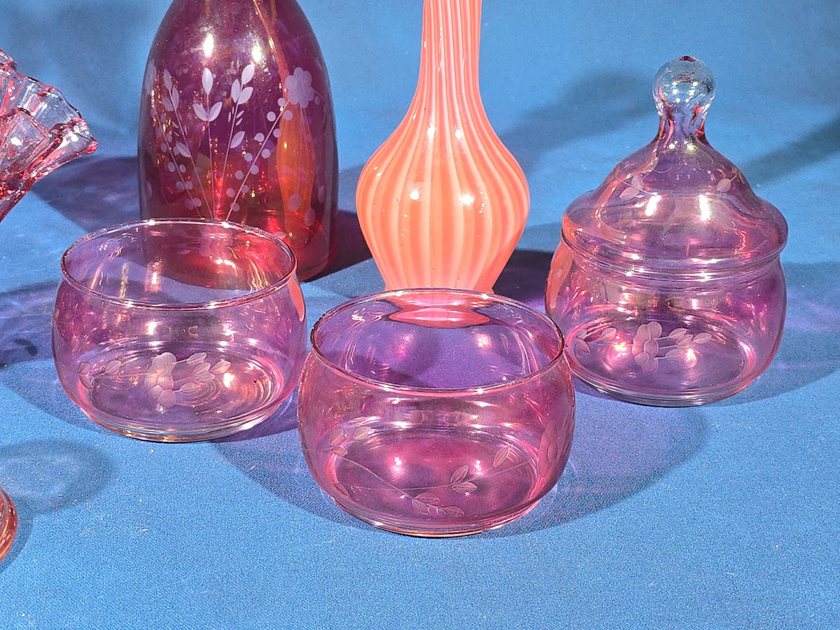 Grouping of Vintage Cranberry and Pink Glass including Ruffled Bowl, Decanter, Striped Bud Vase, Candleholder, and Lidded Jar