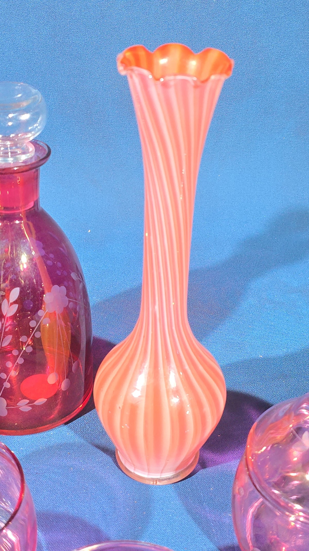 Grouping of Vintage Cranberry and Pink Glass including Ruffled Bowl, Decanter, Striped Bud Vase, Candleholder, and Lidded Jar