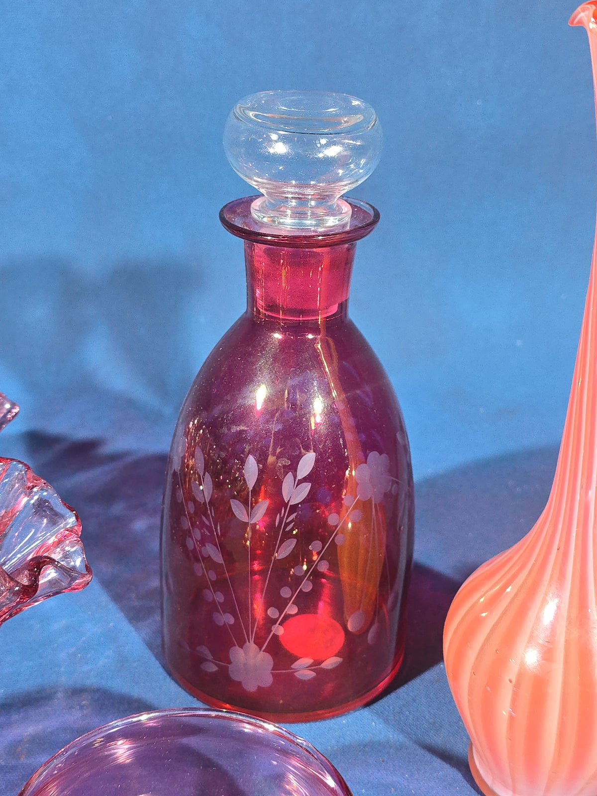 Grouping of Vintage Cranberry and Pink Glass including Ruffled Bowl, Decanter, Striped Bud Vase, Candleholder, and Lidded Jar