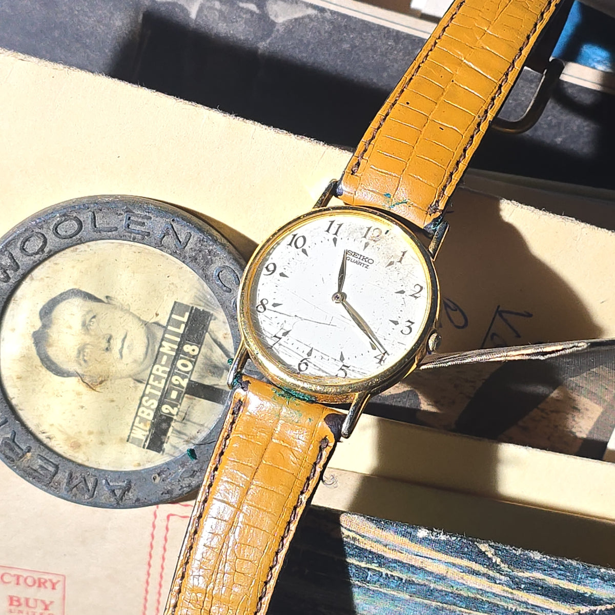 Antique and Vintage Box Lot of Ephemera and Smalls including American Woolen Company Webster Mill Employee Badge, Seiko Quartz Wristwatch, and Religious Keepsake