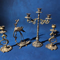 Lot 141 - Grouping of Four Antique and Vintage Brass Candleholders Including Crane on Turtle Figure, Three-Arm Candelabra, and Pair of Candlesticks