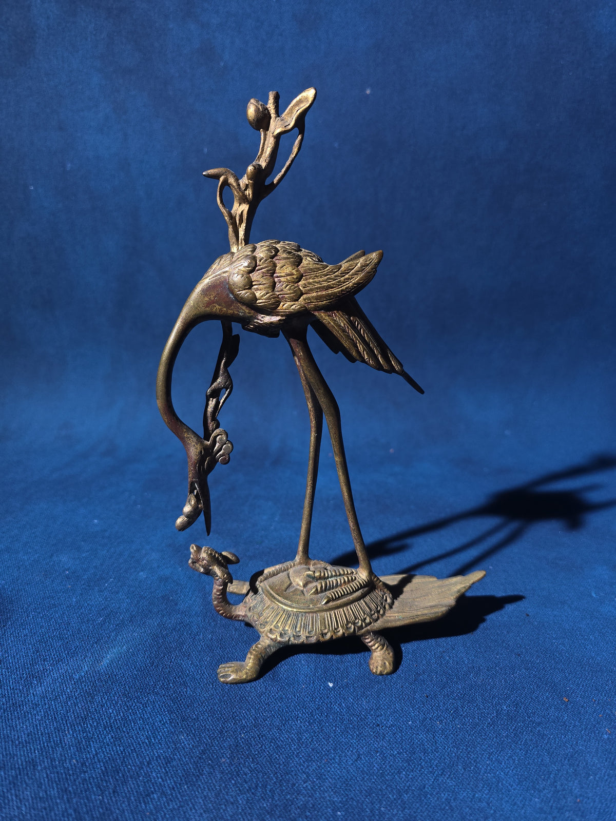 Grouping of Four Antique and Vintage Brass Candleholders including Crane on Turtle Figure, Three-Arm Candelabra, and Pair of Candlesticks