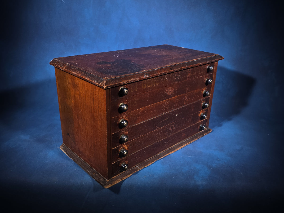 Antique Six-Drawer Spool Cabinet with Stenciled "Geneva" Lettering