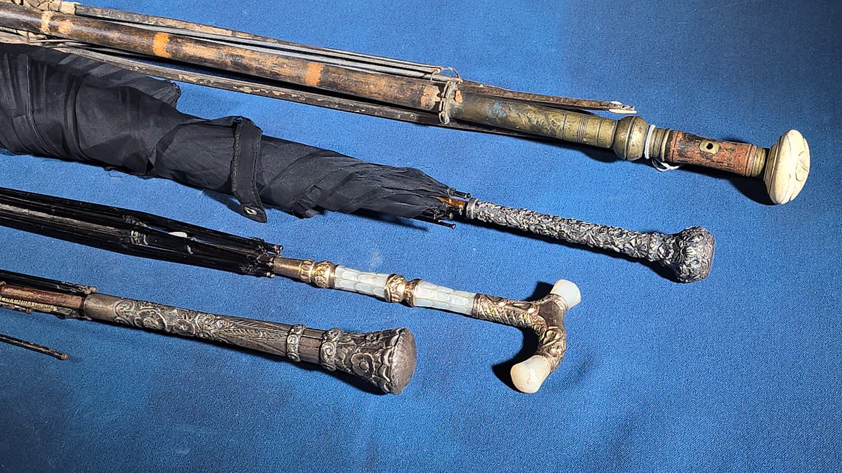 Grouping of Four Antique Parasols and Umbrellas with Ornate Handles including Mother of Pearl, 800 Silver, and Sterling Silver Examples