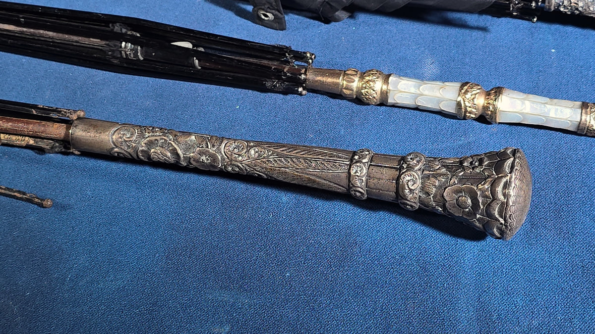 Grouping of Four Antique Parasols and Umbrellas with Ornate Handles including Mother of Pearl, 800 Silver, and Sterling Silver Examples