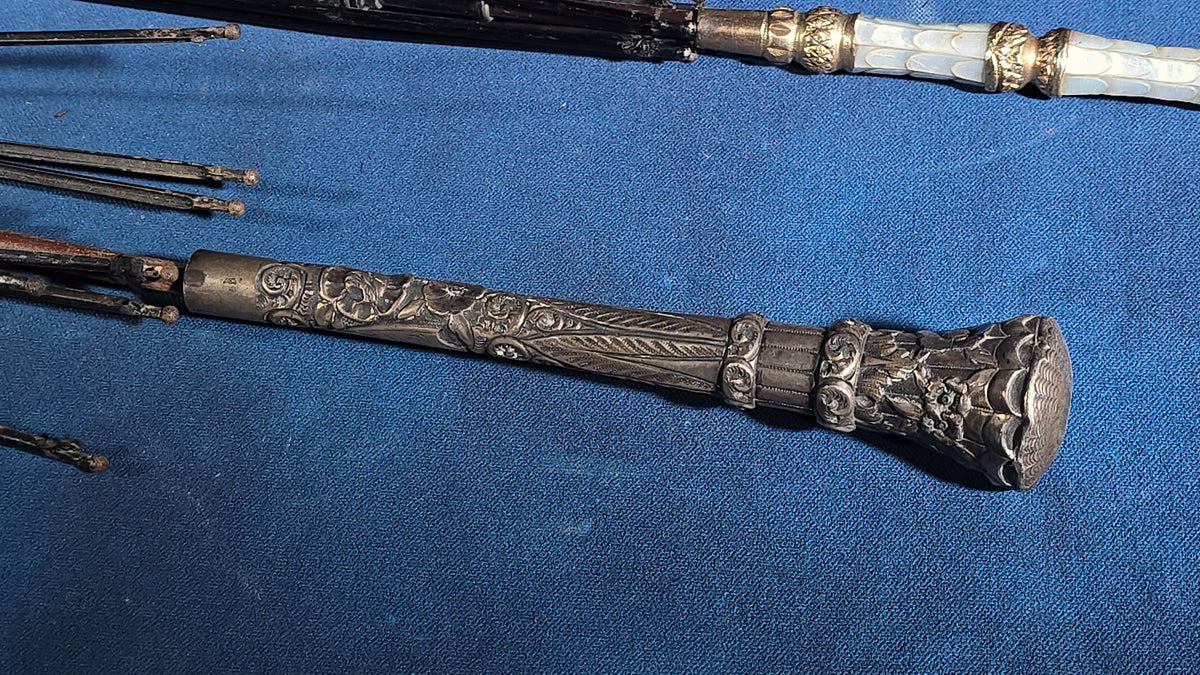 Grouping of Four Antique Parasols and Umbrellas with Ornate Handles including Mother of Pearl, 800 Silver, and Sterling Silver Examples