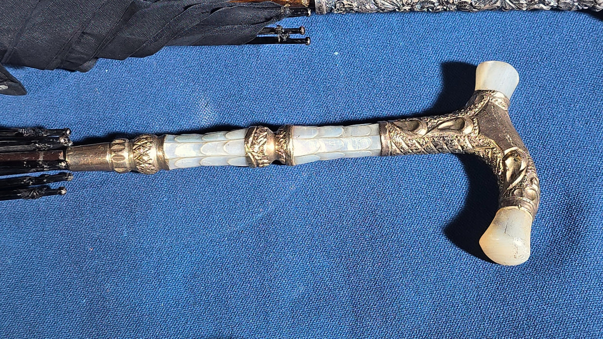 Grouping of Four Antique Parasols and Umbrellas with Ornate Handles including Mother of Pearl, 800 Silver, and Sterling Silver Examples
