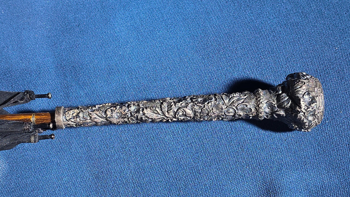 Grouping of Four Antique Parasols and Umbrellas with Ornate Handles including Mother of Pearl, 800 Silver, and Sterling Silver Examples