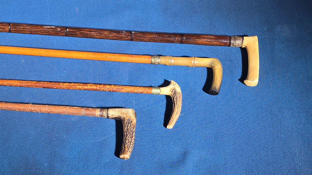 Grouping of Four Antique Walking Canes and Riding Crops including Bone-Handled, Horn-Handled, and Leather-Wrapped Examples