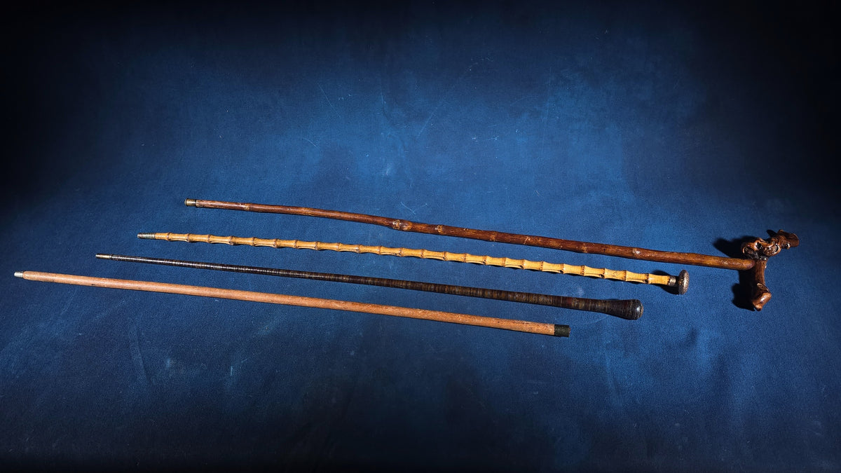 Grouping of Four Antique Walking Canes including Bamboo Cane with Hammered Metal Knob Handle and Engraved Monogram, Burl Wood Cane, and Leather-Wrapped Cane