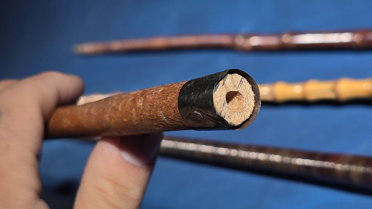Grouping of Four Antique Walking Canes including Bamboo Cane with Hammered Metal Knob Handle and Engraved Monogram, Burl Wood Cane, and Leather-Wrapped Cane