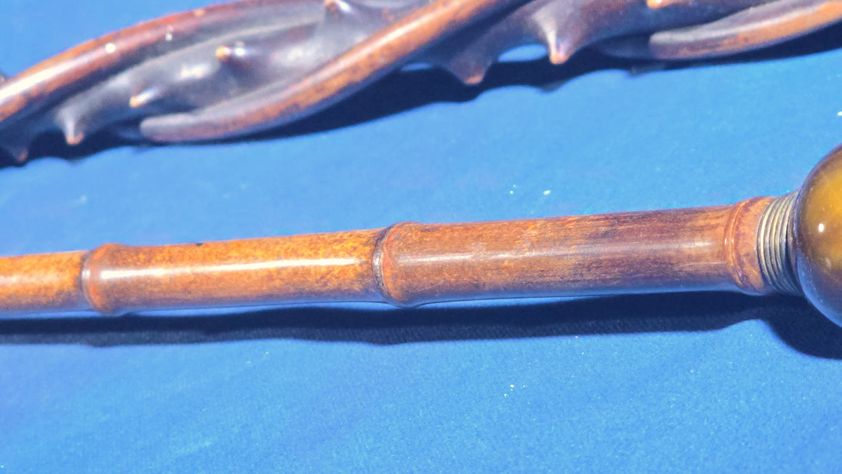 Trio of Antique Walking Canes including Carved Twisted Wood, Bamboo with Tiger's Eye Ball Top, and Ivory-Topped Ebony