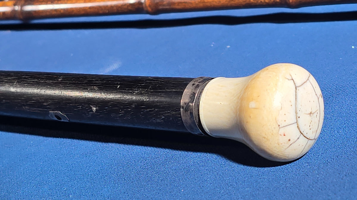 Trio of Antique Walking Canes including Carved Twisted Wood, Bamboo with Tiger's Eye Ball Top, and Ivory-Topped Ebony