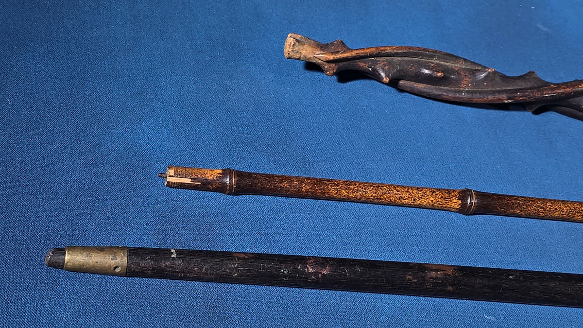 Trio of Antique Walking Canes including Carved Twisted Wood, Bamboo with Tiger's Eye Ball Top, and Ivory-Topped Ebony