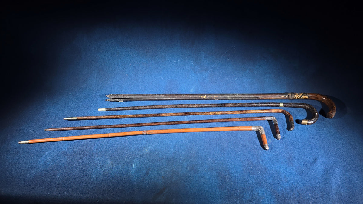 Grouping of Five Antique and Vintage Walking Canes including Tripod Cane, Sterling Silver-Mounted Examples, and Bamboo