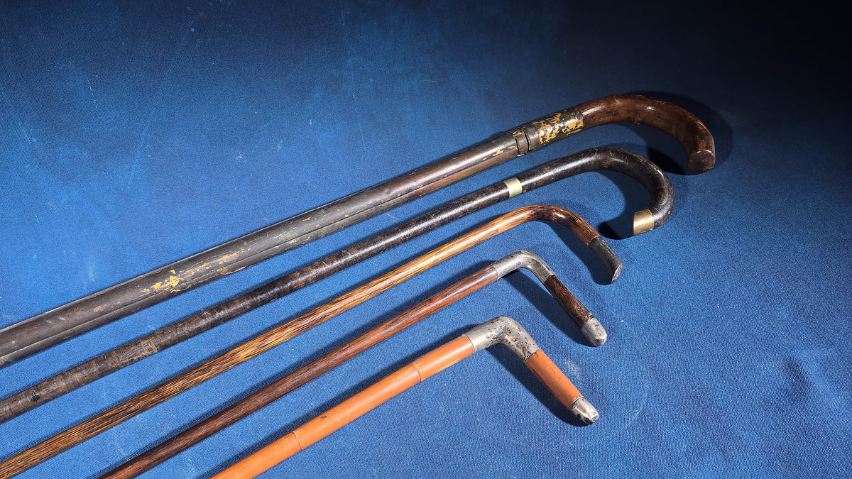 Grouping of Five Antique and Vintage Walking Canes including Tripod Cane, Sterling Silver-Mounted Examples, and Bamboo