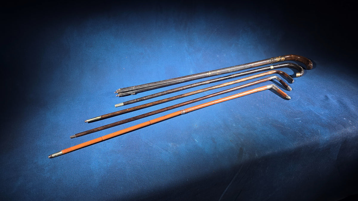 Grouping of Five Antique and Vintage Walking Canes including Tripod Cane, Sterling Silver-Mounted Examples, and Bamboo