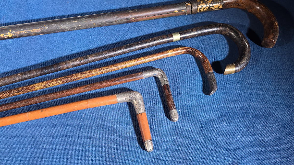 Grouping of Five Antique and Vintage Walking Canes including Tripod Cane, Sterling Silver-Mounted Examples, and Bamboo