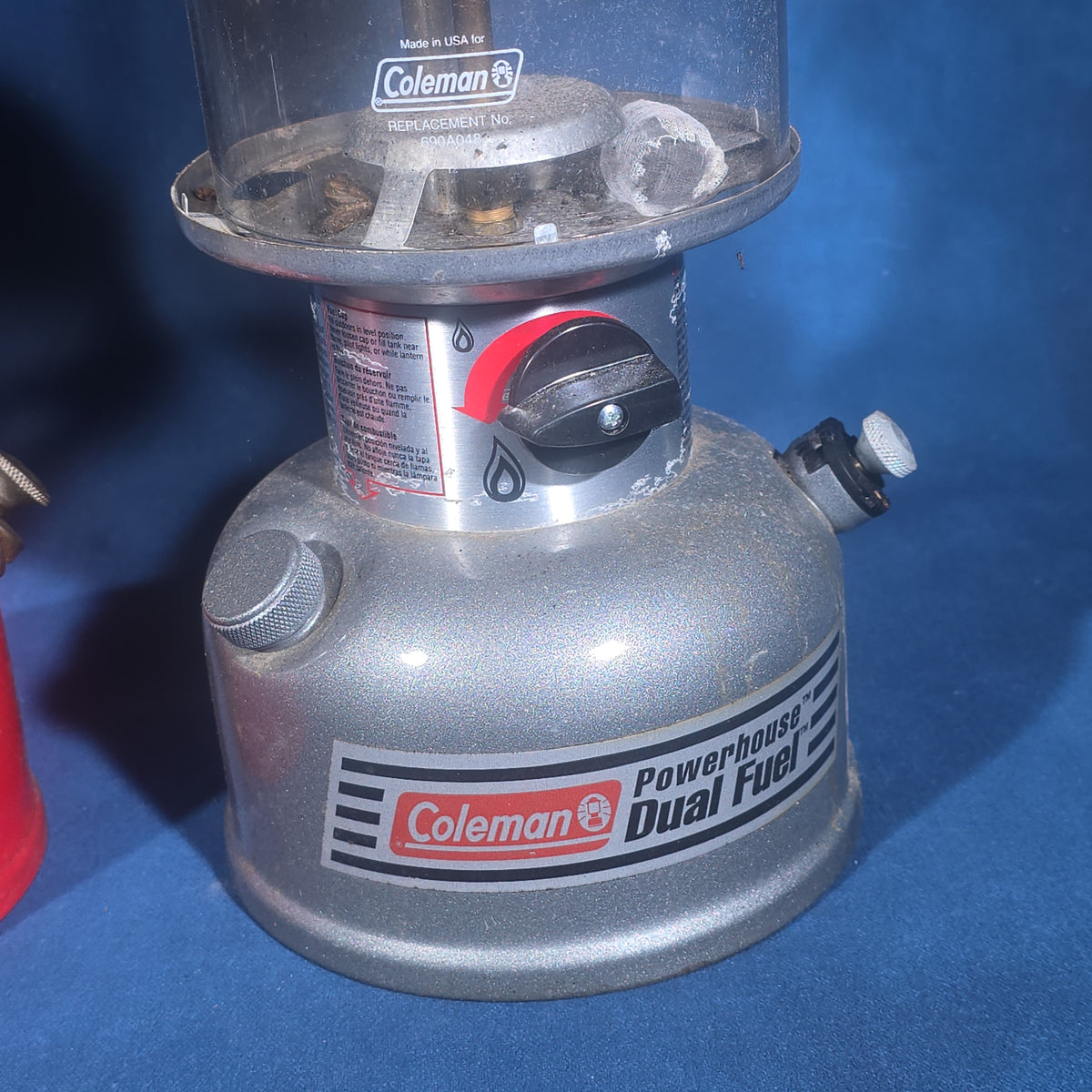 Trio of Vintage and Modern Coleman Camping Lanterns including Red Single-Mantle and Two Powerhouse Dual Fuel Models