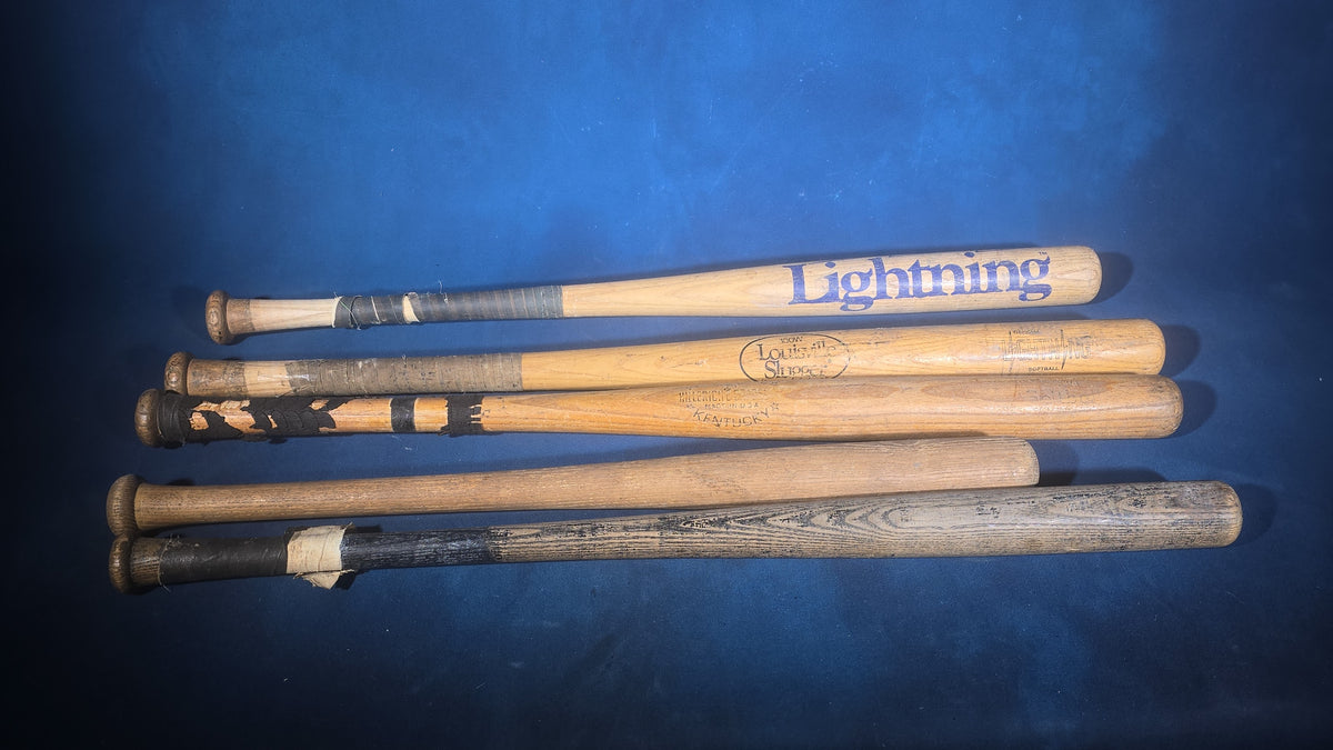Grouping of Five Vintage Wood Softball Bats including Louisville Slugger and Official Lightning