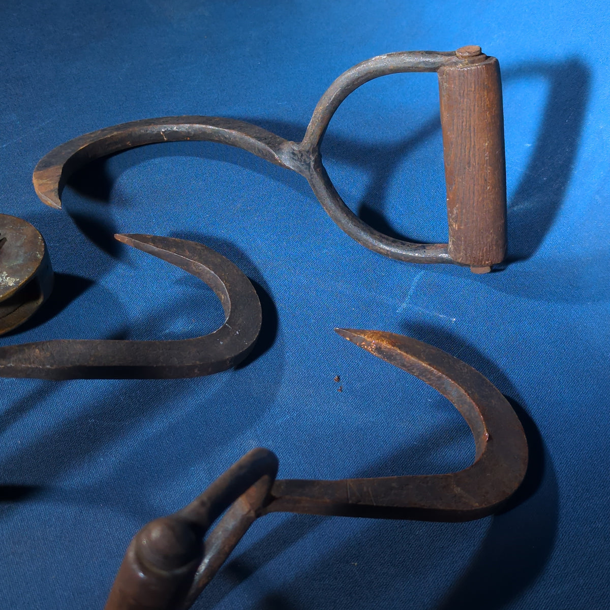 Grouping of Four Antique Iron Hooks including Three Hay/Ice Hooks with Wood Handles and One Pulley Hook