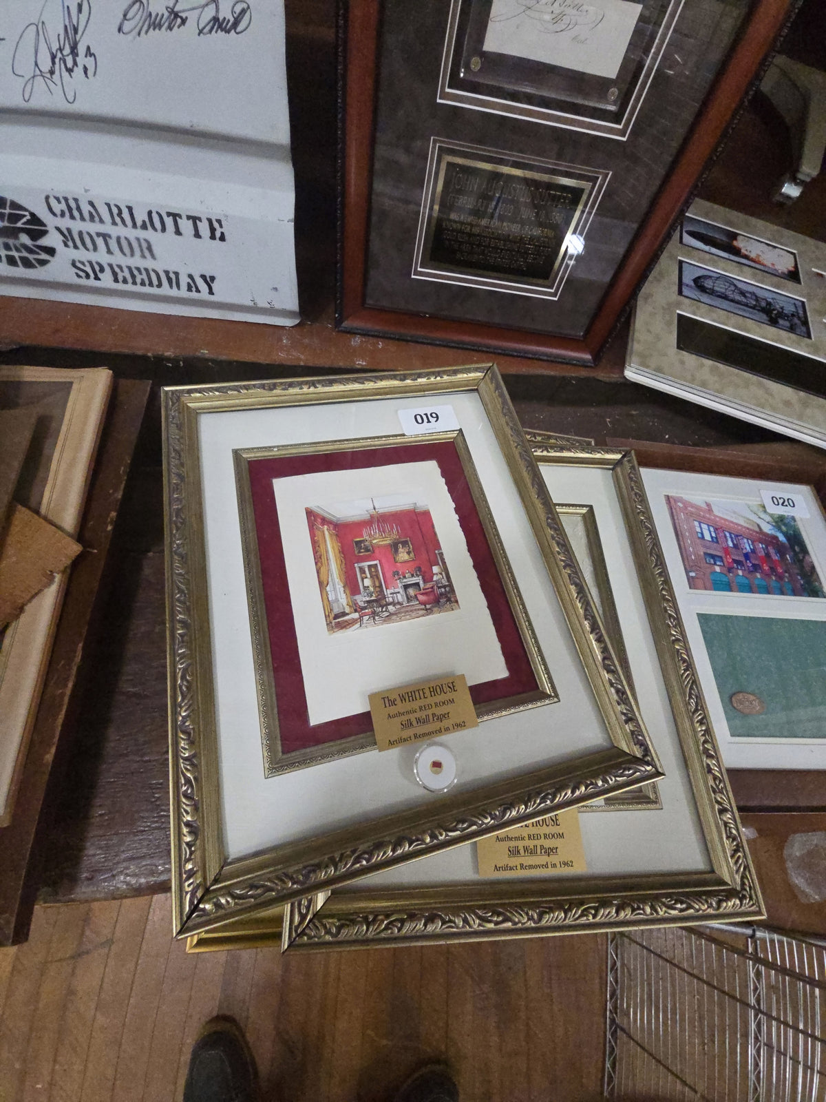 grouping of four framed pieces with swatches of Red Room silk wallpaper from the White House