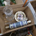 Lot 056 - Box Lot of Porcelain Items Including Rolling Pin, Mini Steins, Children's Plate, and Crystal Decanter