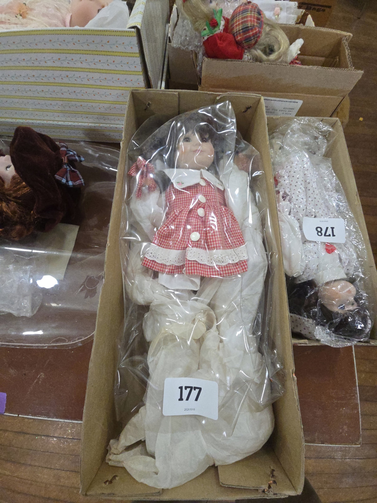 doll in red checkered dress in box
