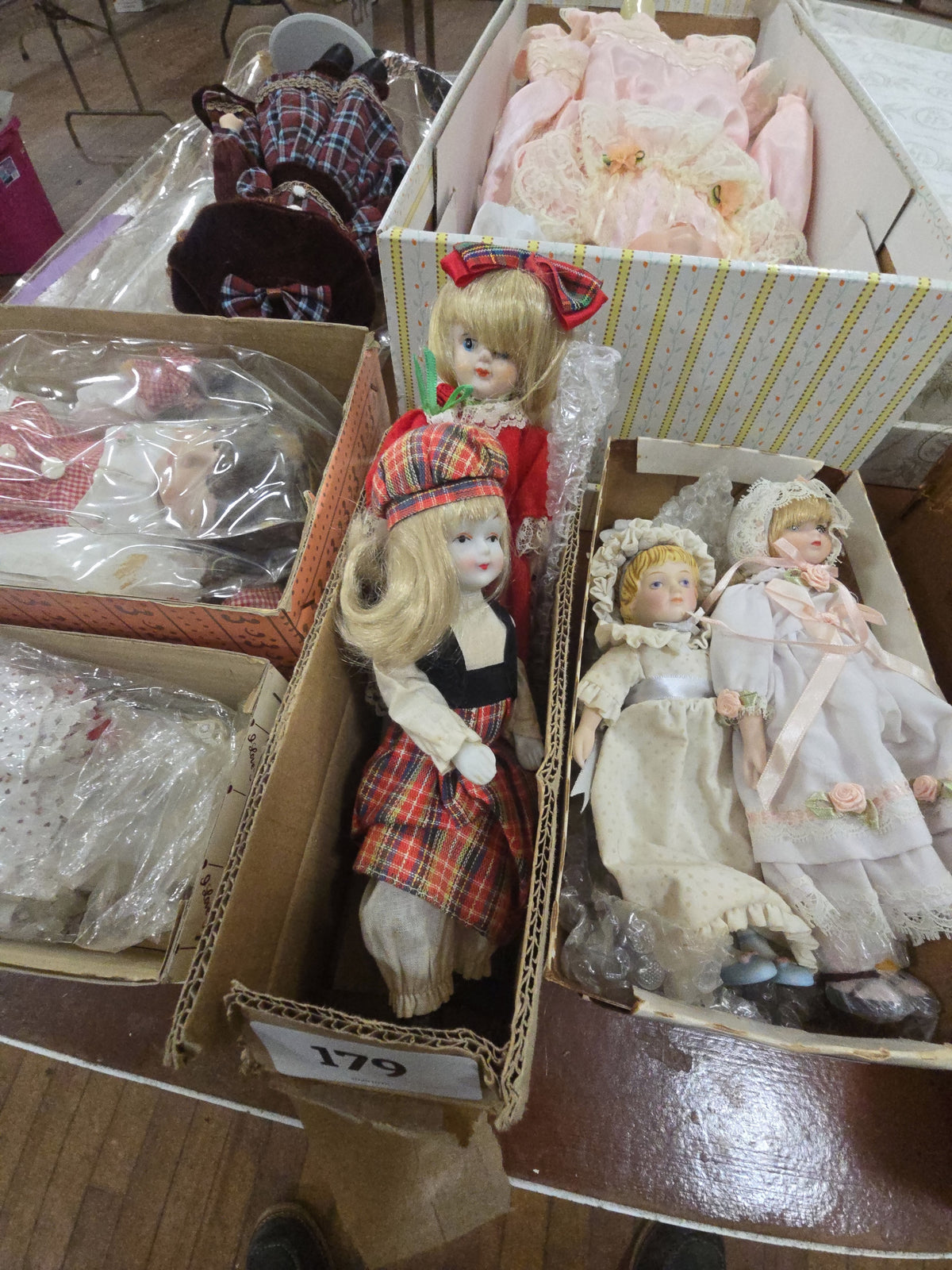 two dolls in box with checkered bow and dress