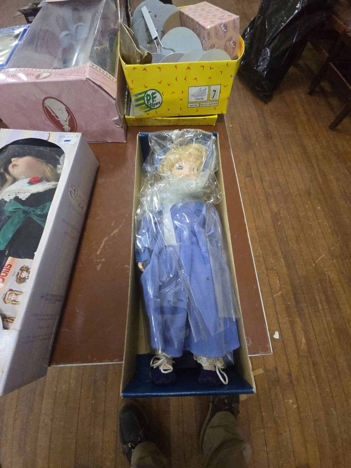 porcelain doll in box with blue dress