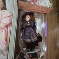 Lot 193 - Porcelain Doll with Maroon Dress and Doll Stand