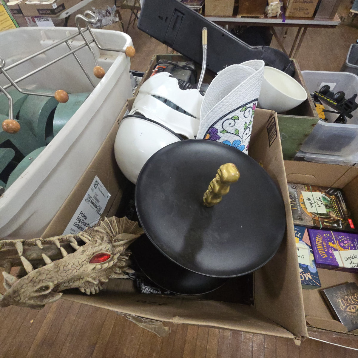 box lot of modern Halloween including tablecloths, Stormtrooper helmet, dragon head, and more