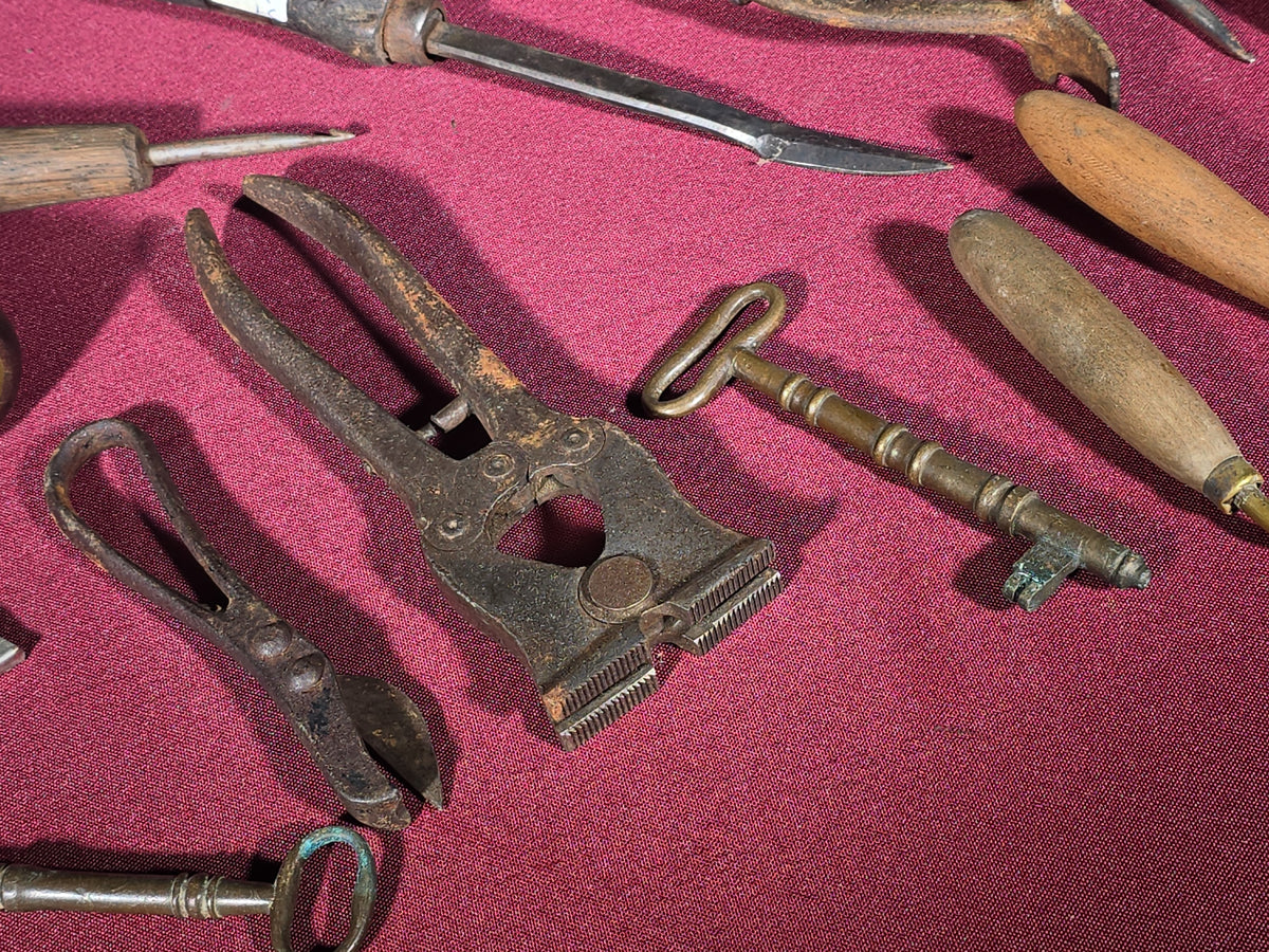 Grouping of Antique and Vintage Small Hand Tools and Hardware including Hunting Knife with Leather Sheath, Miniature Anvil, Dock Cleat, Skeleton Keys, and Awls